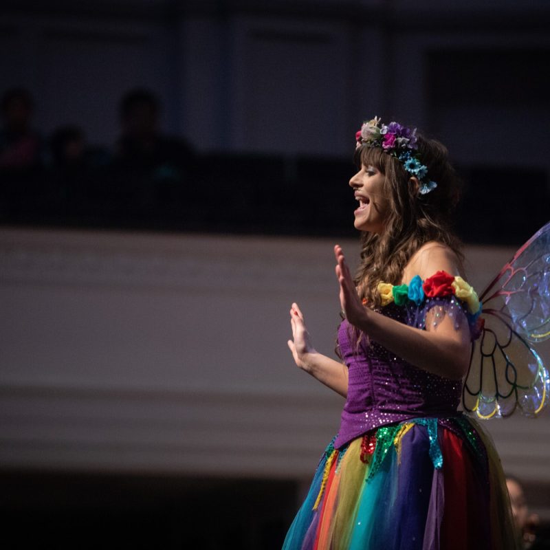 a woman standing in front of a microphone